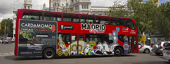 RENOLIT_Printed Automotive City Tour bus with tourists in Madrid 